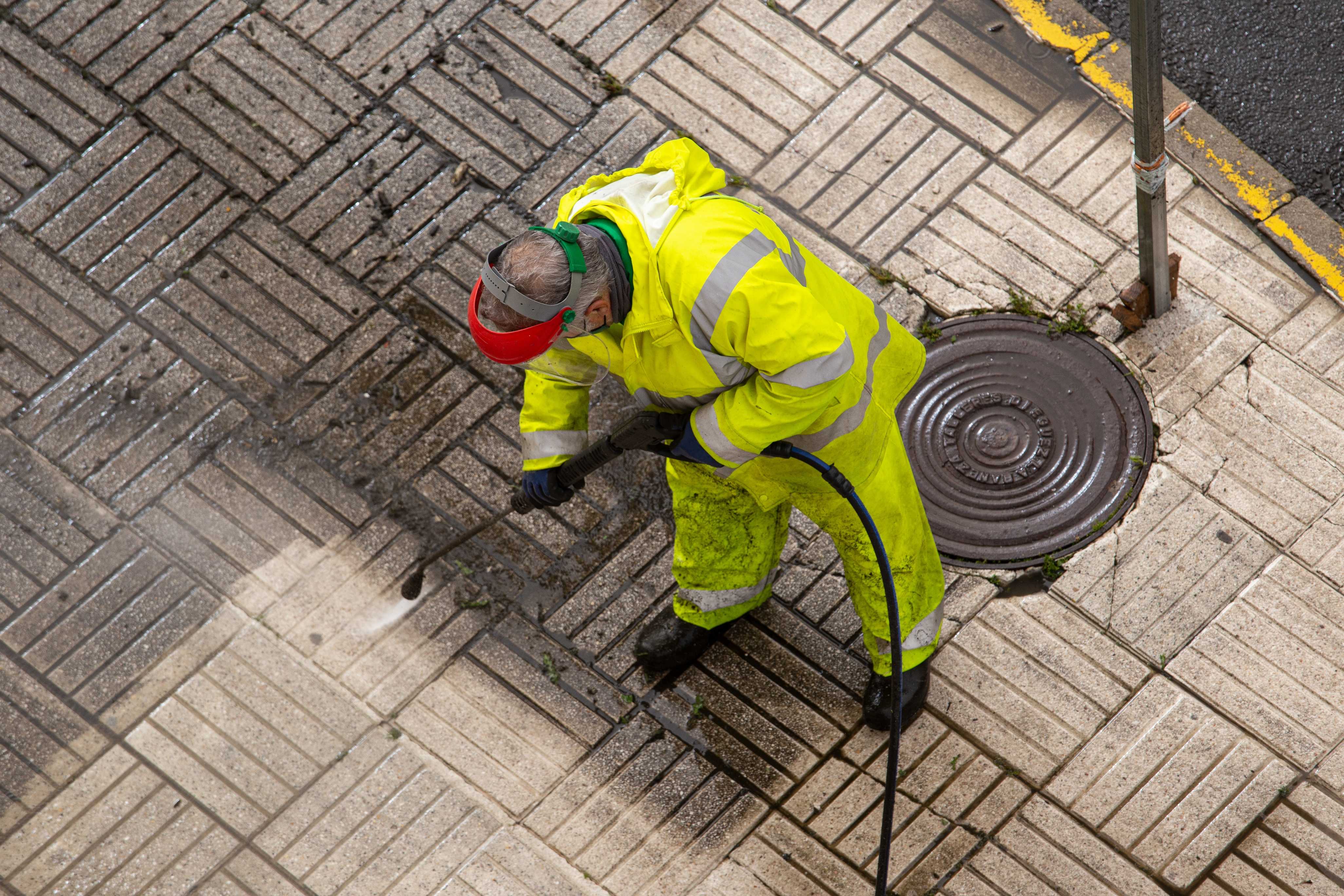 worker cleaning street sidewalks